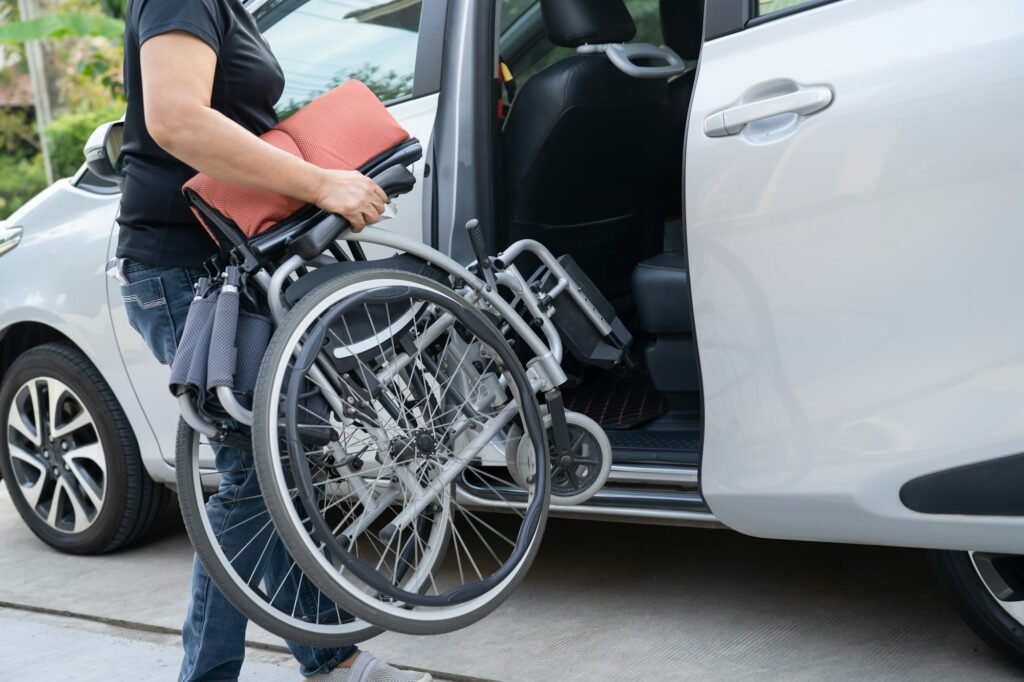 Asian disability woman on wheelchair getting in her car, Accessibility concept.